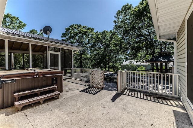 21509 Rockwell Dr, Lebanon, MO 65536 - view of patio / terrace with a hot tub, a gazebo, and a sunroom