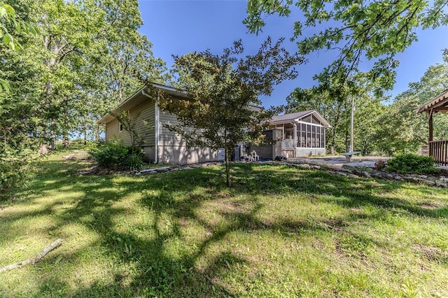 21509 Rockwell Dr, Lebanon, MO 65536 - view of green lawn with a sunroom