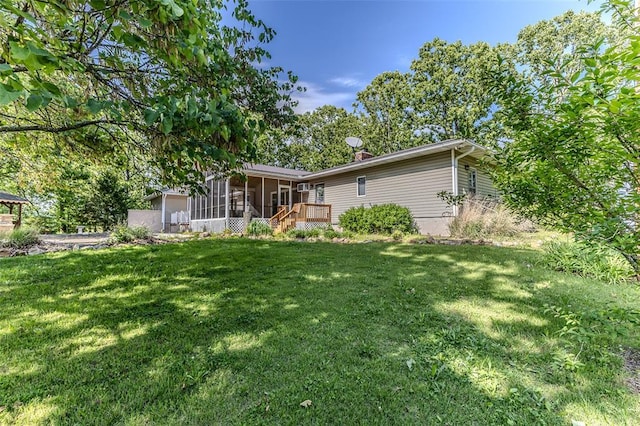 21509 Rockwell Dr, Lebanon, MO 65536 - rear view of property featuring a sunroom and a yard