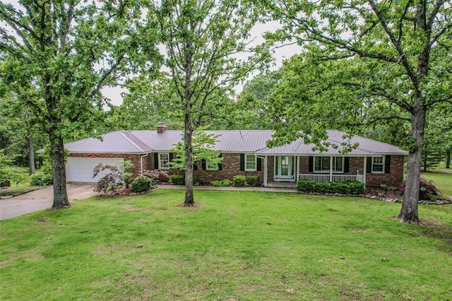 21509 Rockwell Dr, Lebanon, MO 65536 - ranch-style home with covered porch, driveway, a garage, a chimney, and a front lawn