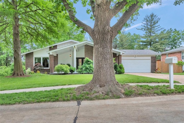 402 Glan Tai Dr, Manchester, MO 63011 - mid-century modern home with brick siding, an attached garage, driveway, and a front lawn