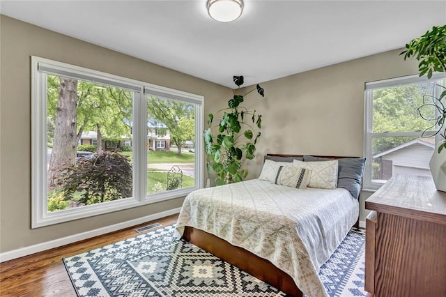 402 Glan Tai Dr, Manchester, MO 63011 - bedroom featuring multiple windows, baseboards, and wood finished floors