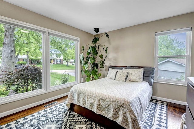 402 Glan Tai Dr, Manchester, MO 63011 - bedroom with baseboards, multiple windows, and wood finished floors