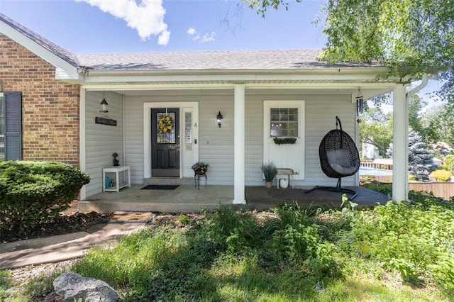 4 Aken Ct, Saint Peters, MO 63376 - entrance to property featuring covered porch, a shingled roof, and brick siding