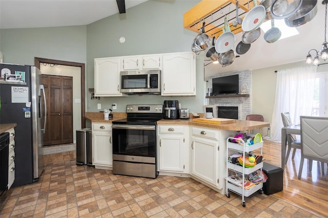 4 Aken Ct, Saint Peters, MO 63376 - kitchen with stainless steel appliances, a peninsula, white cabinets, and high vaulted ceiling