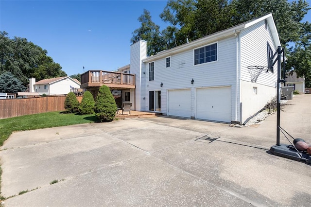 4 Aken Ct, Saint Peters, MO 63376 - rear view of house with a garage, a wooden deck, driveway, and a chimney