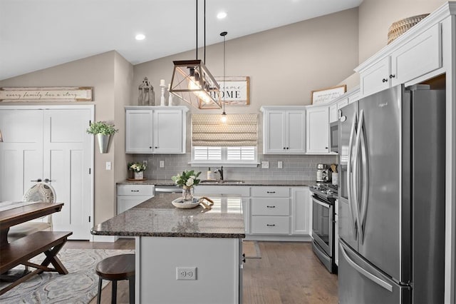 536 W 5th St, Saint Jacob, IL 62281 - kitchen featuring appliances with stainless steel finishes, a sink, a breakfast bar, white cabinets, and backsplash