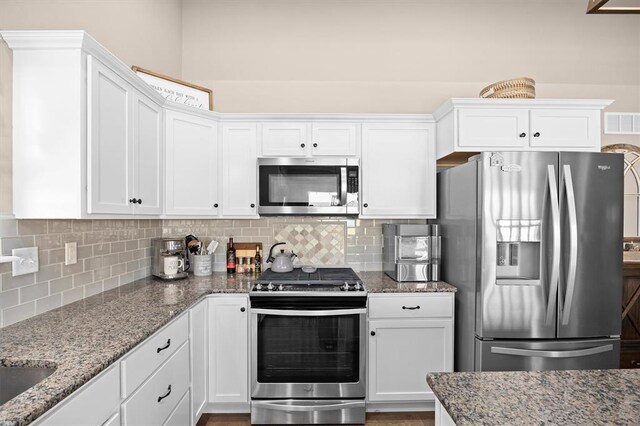 536 W 5th St, Saint Jacob, IL 62281 - kitchen with stainless steel appliances, white cabinetry, and backsplash