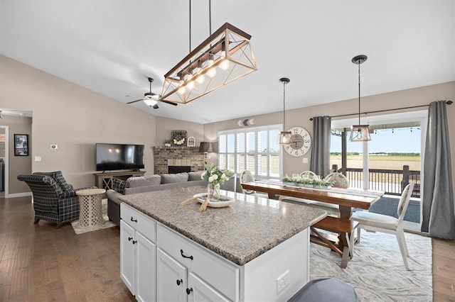 536 W 5th St, Saint Jacob, IL 62281 - kitchen with lofted ceiling, ceiling fan, wood finished floors, light stone countertops, and a fireplace