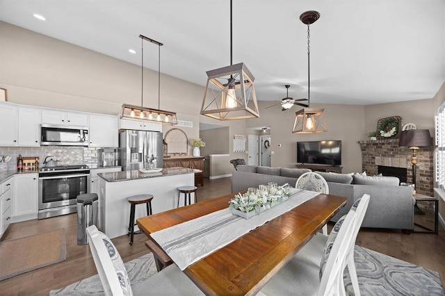 536 W 5th St, Saint Jacob, IL 62281 - dining area featuring a ceiling fan, a brick fireplace, dark wood-style floors, and recessed lighting