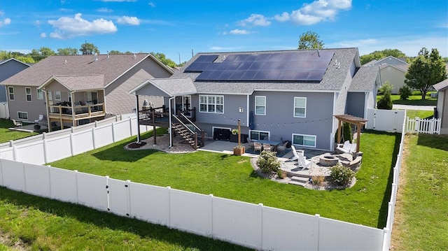 536 W 5th St, Saint Jacob, IL 62281 - rear view of property with an outdoor fire pit, roof mounted solar panels, a patio, a shingled roof, and stairs