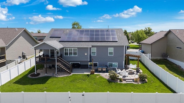 536 W 5th St, Saint Jacob, IL 62281 - rear view of property with an outdoor fire pit, roof mounted solar panels, roof with shingles, and a patio area