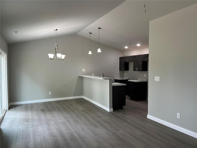 10 Jaybird Ct, Montgomery City, MO 63361 - kitchen with baseboards, a chandelier, dark wood-style floors, a peninsula, and vaulted ceiling