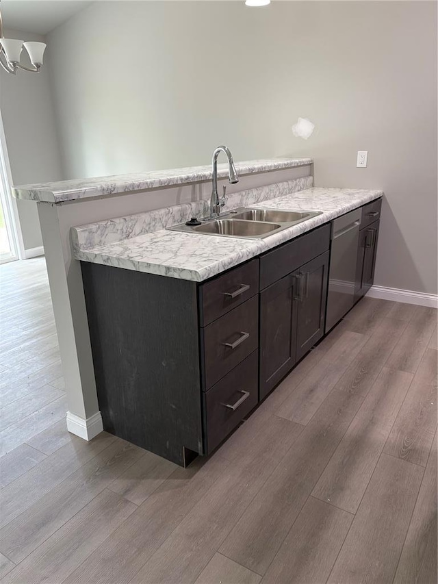 10 Jaybird Ct, Montgomery City, MO 63361 - kitchen featuring a sink, dishwasher, light wood finished floors, light countertops, and baseboards