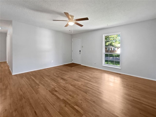 2540 Courtyard Pl, Florissant, MO 63031 - unfurnished room with wood finished floors, ceiling fan, a textured ceiling, and baseboards