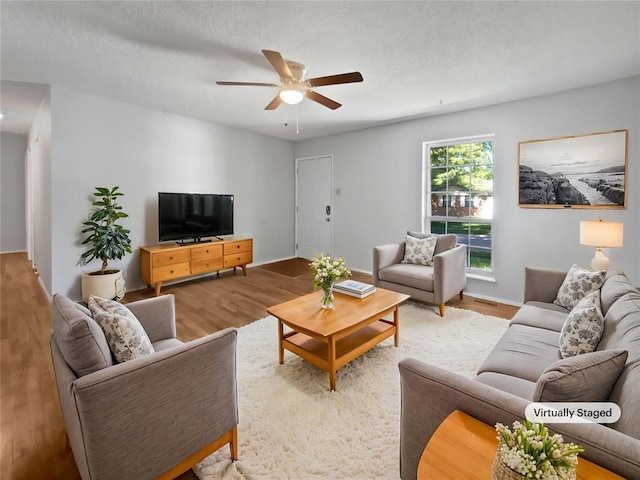 2540 Courtyard Pl, Florissant, MO 63031 - living room featuring a ceiling fan, wood finished floors, and baseboards