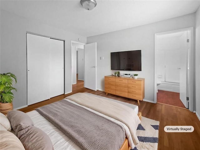 2540 Courtyard Pl, Florissant, MO 63031 - bedroom featuring dark wood finished floors, a closet, and ensuite bath
