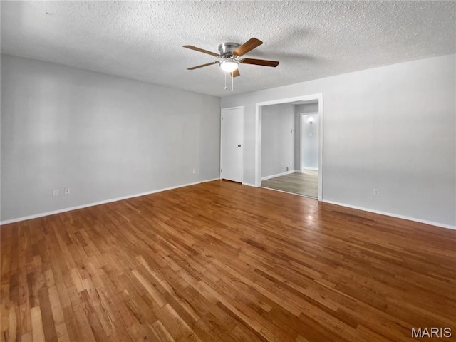 2540 Courtyard Pl, Florissant, MO 63031 - spare room with a ceiling fan, wood finished floors, baseboards, and a textured ceiling