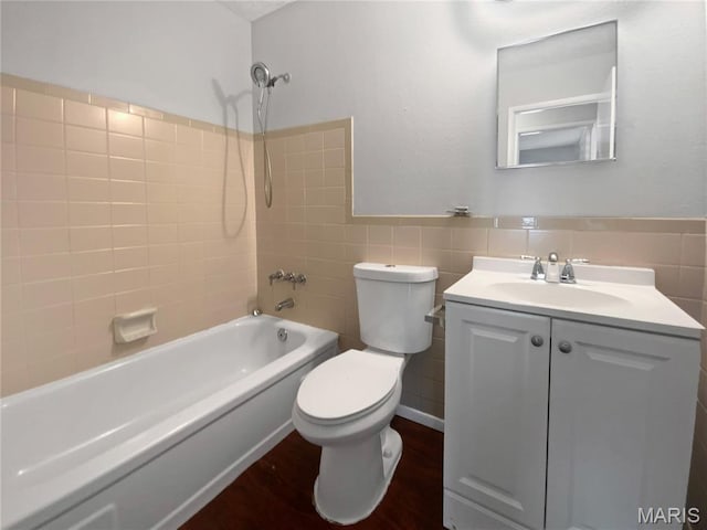 2540 Courtyard Pl, Florissant, MO 63031 - full bath featuring toilet, vanity, shower / bathtub combination, tile walls, and wood finished floors