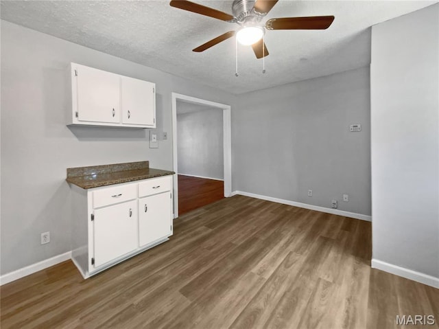 2540 Courtyard Pl, Florissant, MO 63031 - empty room featuring a ceiling fan, wood finished floors, baseboards, and a textured ceiling