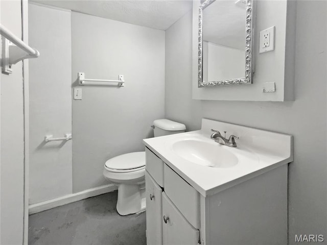 2540 Courtyard Pl, Florissant, MO 63031 - bathroom featuring vanity, finished concrete flooring, toilet, and baseboards