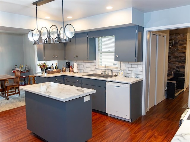 3930 Commanche Ave, Hannibal, MO 63401 - kitchen featuring dishwasher, a sink, gray cabinets, decorative backsplash, and a kitchen island