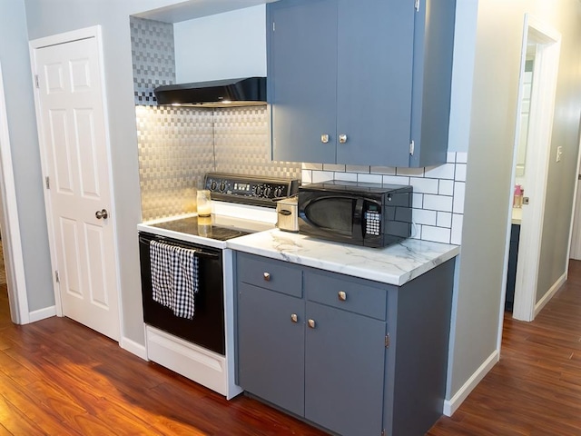 3930 Commanche Ave, Hannibal, MO 63401 - kitchen with electric range, black microwave, blue cabinetry, and dark wood-type flooring