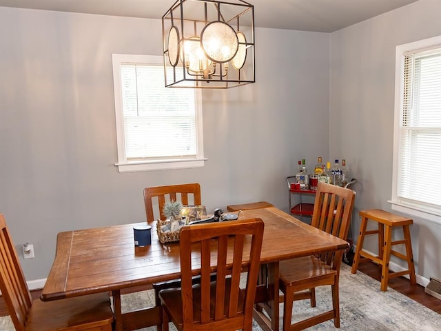 3930 Commanche Ave, Hannibal, MO 63401 - dining space featuring a chandelier, baseboards, and wood finished floors