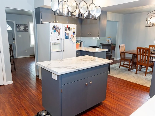 3930 Commanche Ave, Hannibal, MO 63401 - kitchen featuring white refrigerator with ice dispenser, dark wood-style floors, blue cabinetry, and gray cabinets