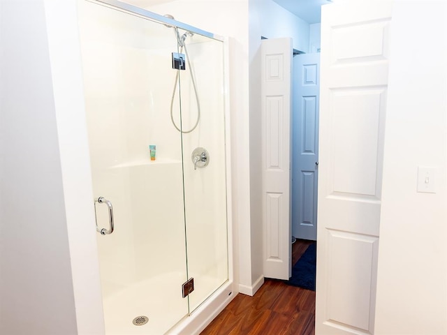 3930 Commanche Ave, Hannibal, MO 63401 - full bathroom with a shower stall, wood finished floors, and baseboards