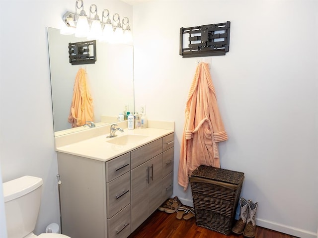 3930 Commanche Ave, Hannibal, MO 63401 - bathroom featuring vanity, toilet, and wood finished floors