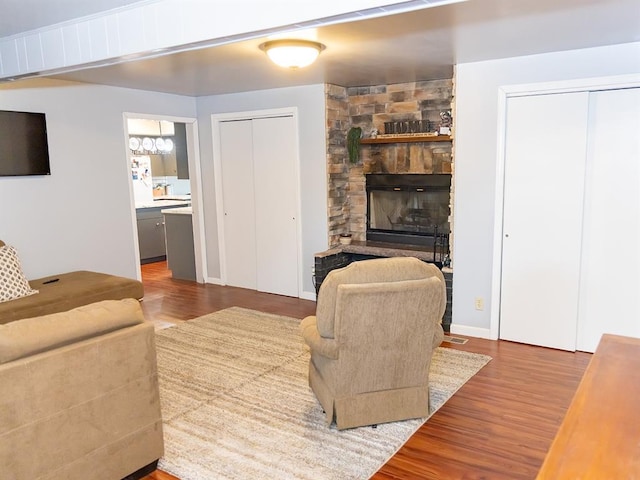 3930 Commanche Ave, Hannibal, MO 63401 - living area with wood finished floors, a fireplace, and a chandelier