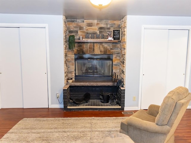 3930 Commanche Ave, Hannibal, MO 63401 - living room with wood finished floors, baseboards, and a stone fireplace