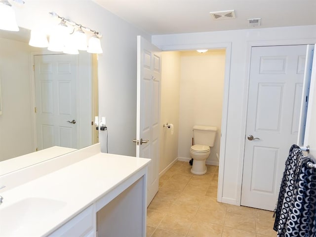 3930 Commanche Ave, Hannibal, MO 63401 - bathroom with vanity, toilet, and tile patterned floors