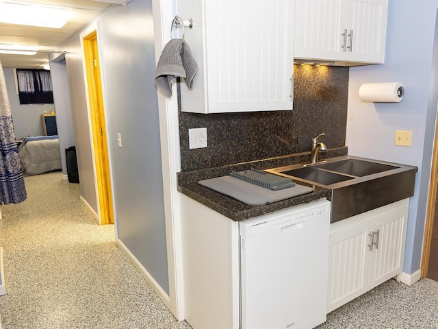 3930 Commanche Ave, Hannibal, MO 63401 - kitchen featuring dishwasher, backsplash, white cabinetry, and dark countertops