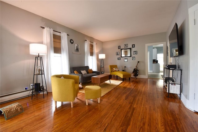 living area with wood finished floors and baseboards