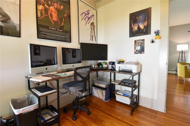 office area featuring wood finished floors and a baseboard radiator