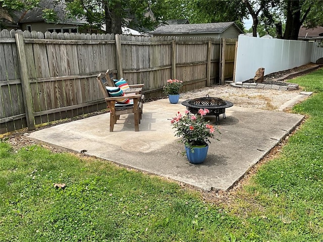 fenced backyard with a fire pit and a patio area