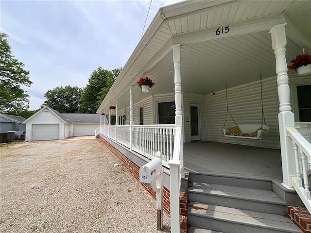 view of property exterior featuring a porch, an outbuilding, and a garage