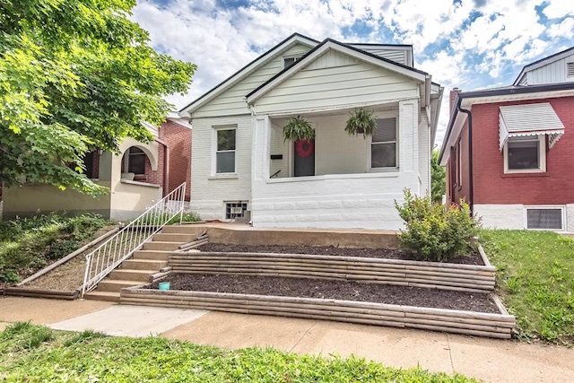 5156 Christy Ave, Saint Louis, MO 63116 - view of front of home with a garden, brick siding, and stairs
