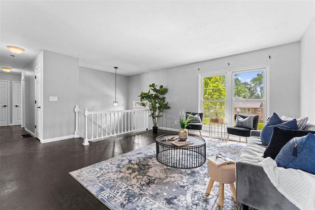 living room with baseboards and wood finished floors