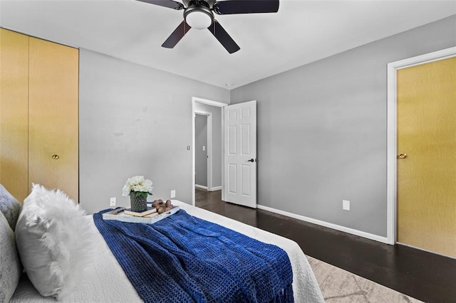 bedroom featuring wood finished floors, baseboards, and ceiling fan