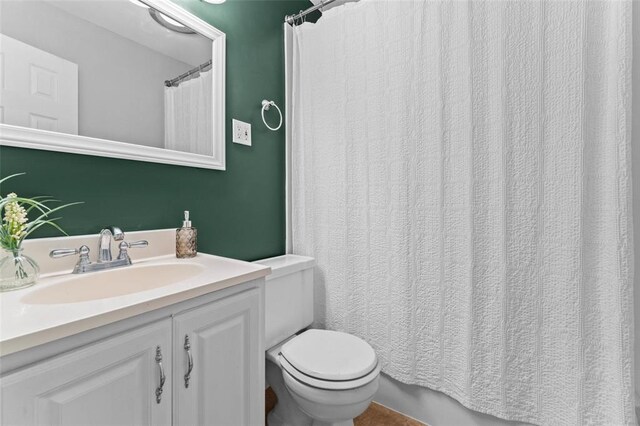 full bathroom with toilet, vanity, and a shower with shower curtain