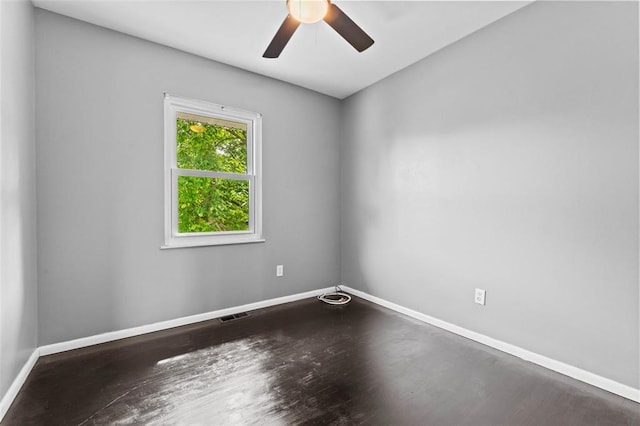 unfurnished room with baseboards, ceiling fan, and wood finished floors