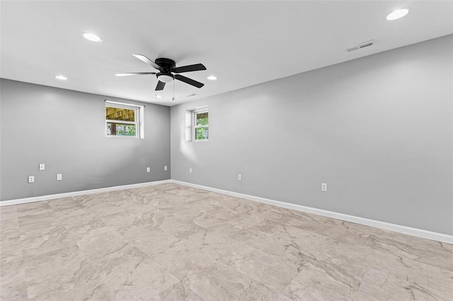 empty room with recessed lighting, a ceiling fan, and baseboards