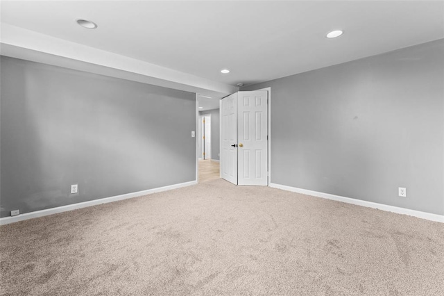 carpeted spare room with recessed lighting and baseboards