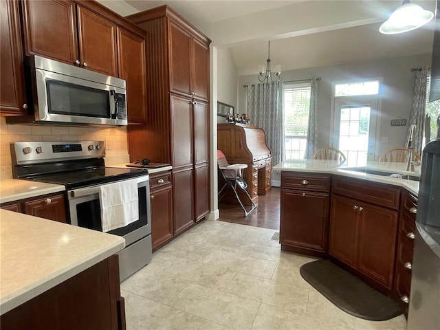 835 Bay Hill Blvd, Union, MO 63084 - kitchen with appliances with stainless steel finishes, light countertops, tasteful backsplash, a chandelier, and a sink