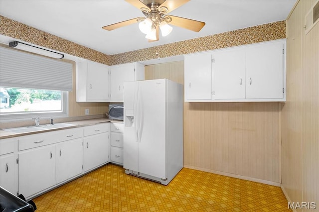 1816 N Belt, Belleville, IL 62221 - kitchen with white refrigerator with ice dispenser, light flooring, stainless steel microwave, white cabinetry, and light countertops