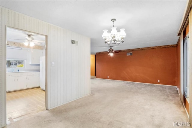 1816 N Belt, Belleville, IL 62221 - spare room featuring a ceiling fan, a chandelier, light carpet, and wallpapered walls