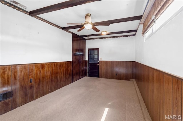 1816 N Belt, Belleville, IL 62221 - empty room featuring wood walls, wainscoting, beam ceiling, and ceiling fan
